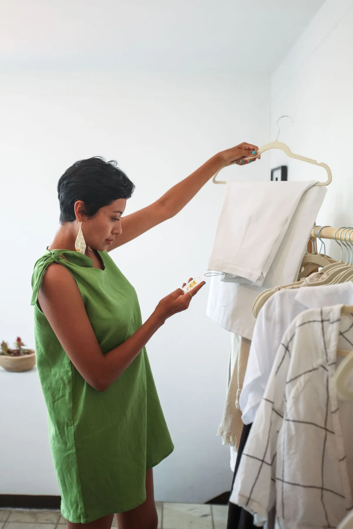 A woman looking through clothes on a boutique rail